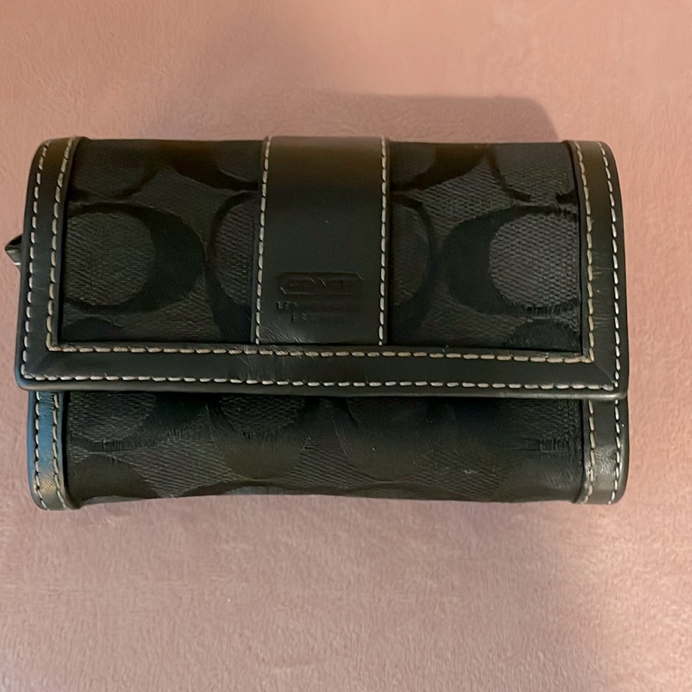 Small black Coach wallet. Normal wear. No tearsz Zipper works. Closure works.